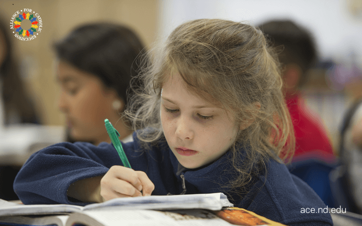 Student writing at desk