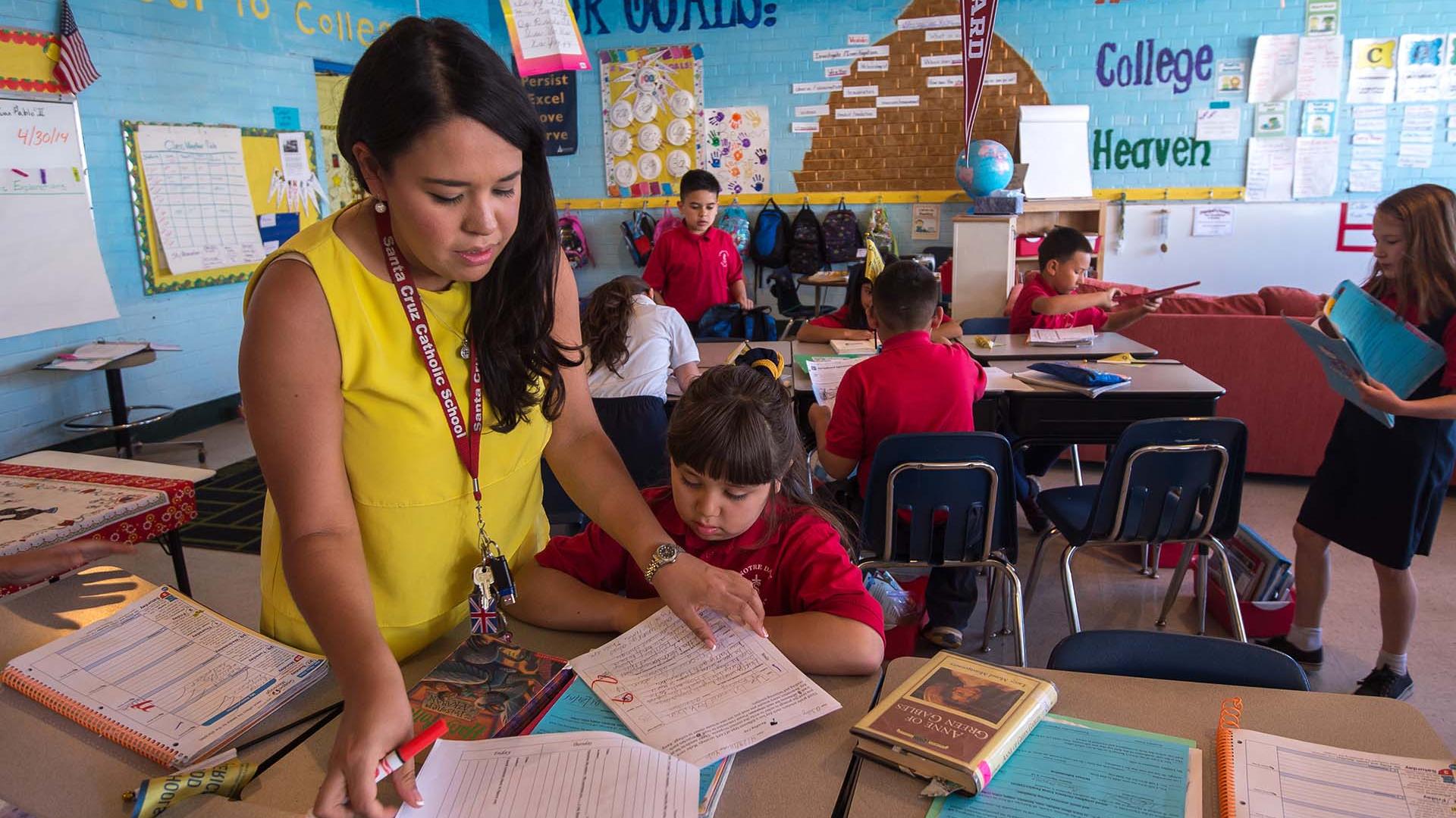 Teacher working with student in classroom