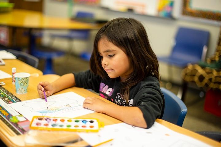 student coloring at desk