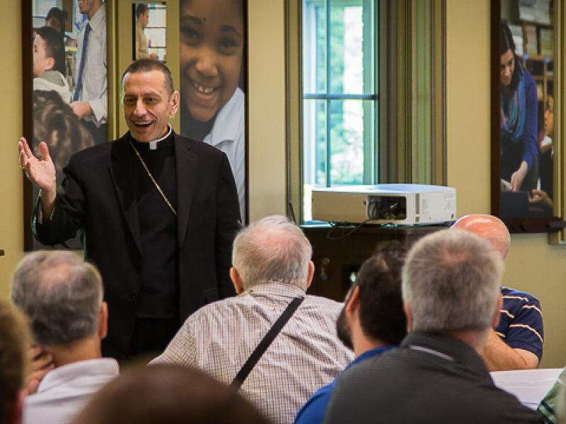 Priest speaking to audience