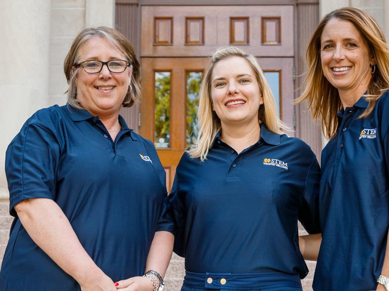 Women smiling outside building