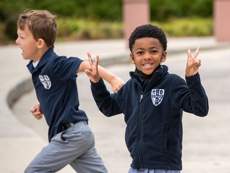 Two boys run out to recess